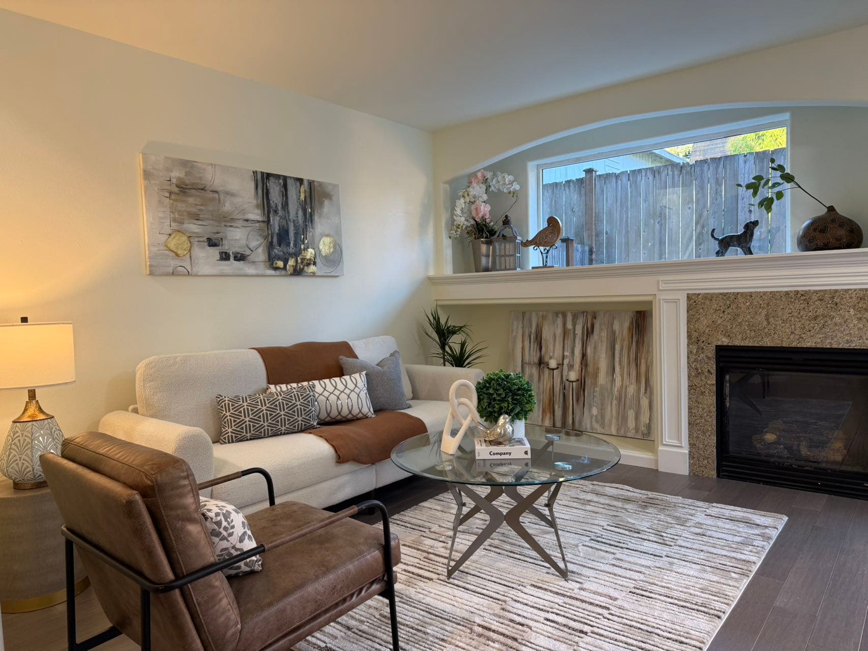 Living Room — White Sofa, Leather Chair & Stone Fireplace