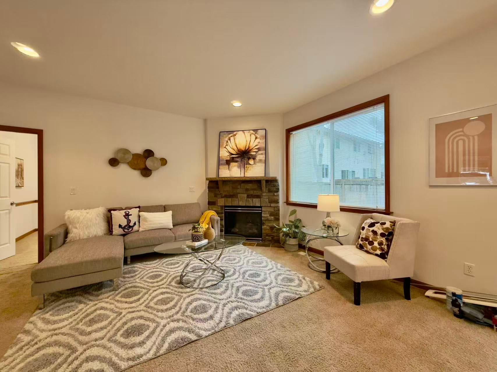 Living Room — Gray Sectional & Stone Corner Fireplace