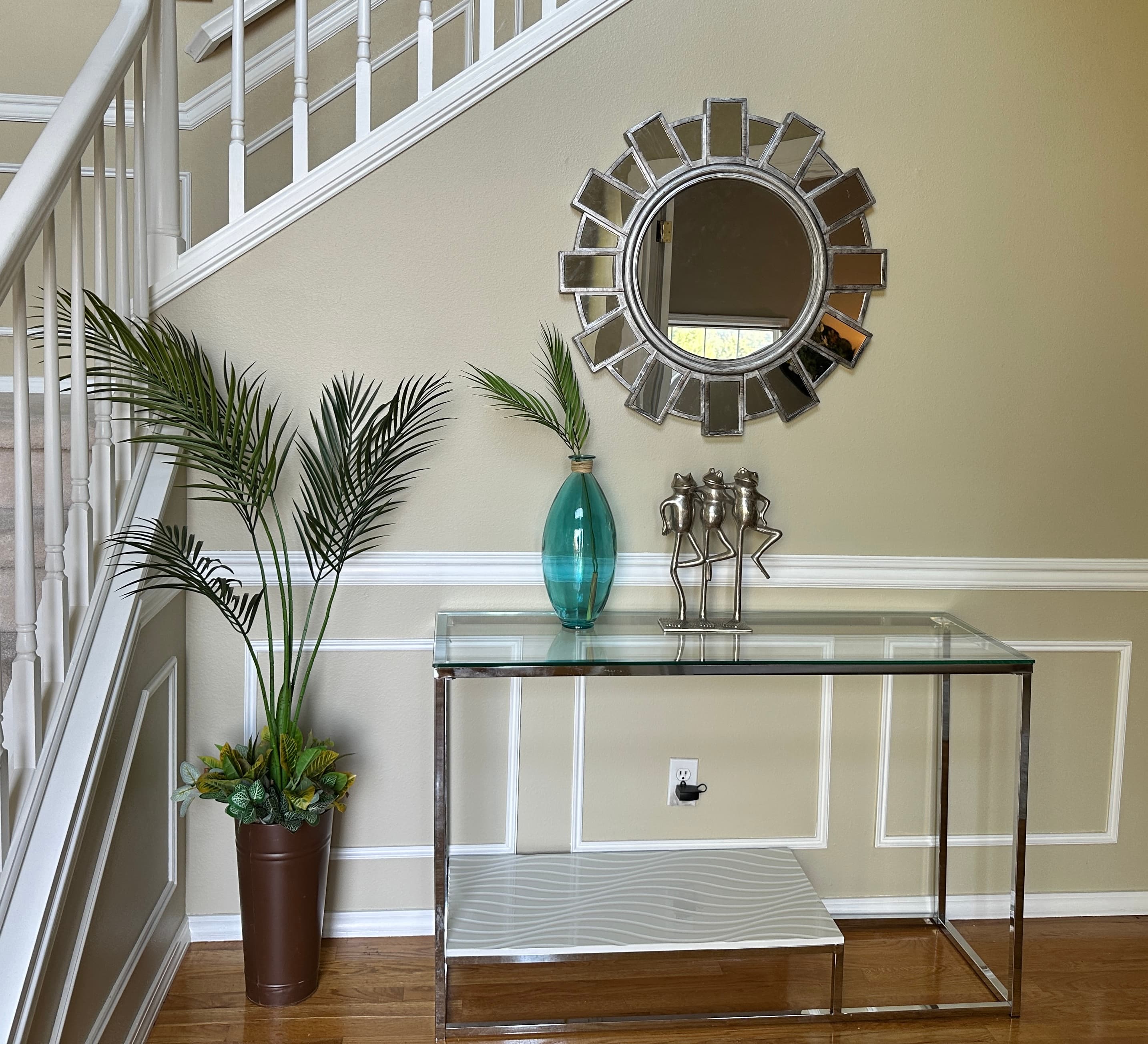 Entryway — Chrome Glass Console, Sunburst Mirror & Palm Plant by Staircase
