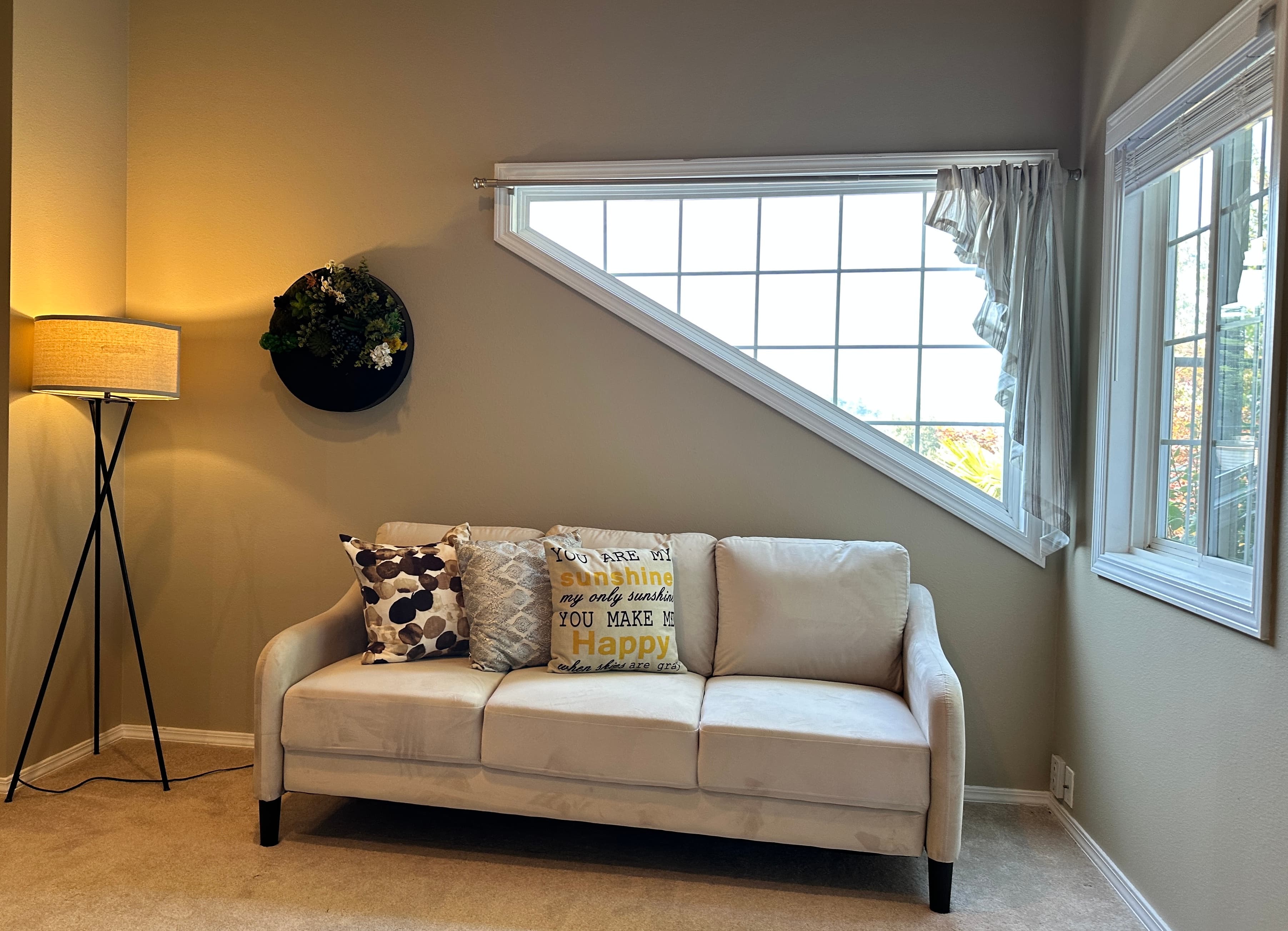 Sitting Area — Cream Sofa, Tripod Floor Lamp & Vaulted Ceiling Windows