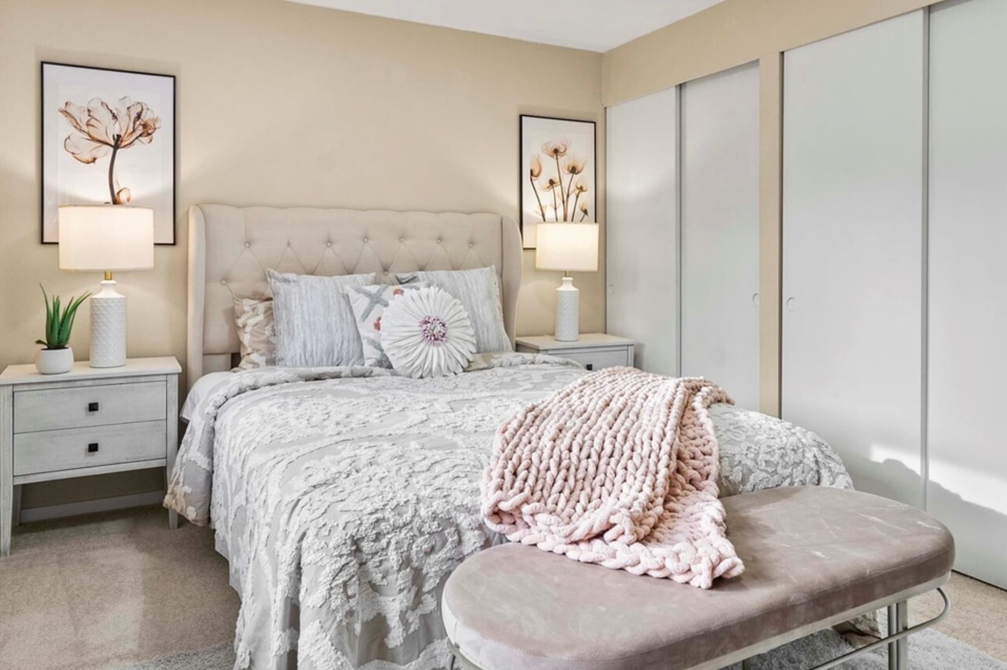 Primary Bedroom — Full View with Pink Chunky Knit Throw & Bench