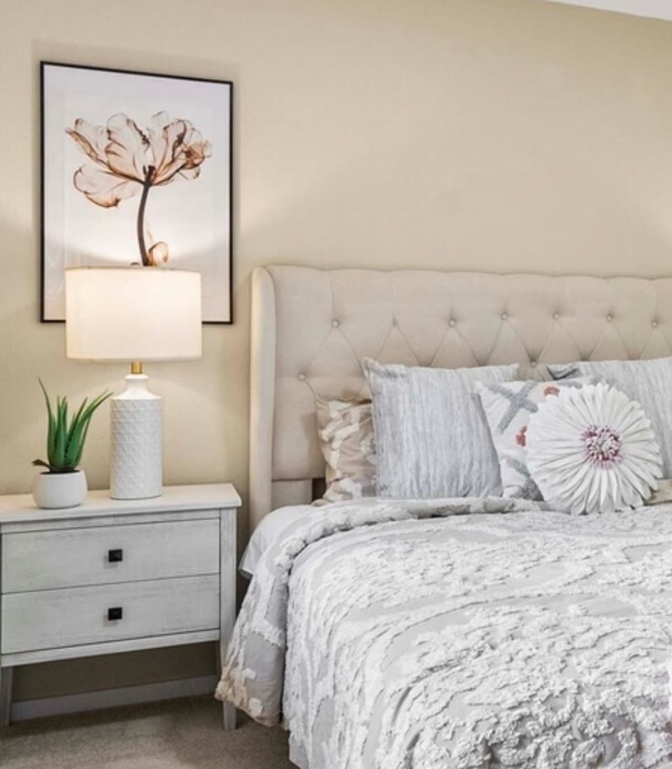 Primary Bedroom — Beige Tufted Headboard, Floral Bedding & Botanical Art