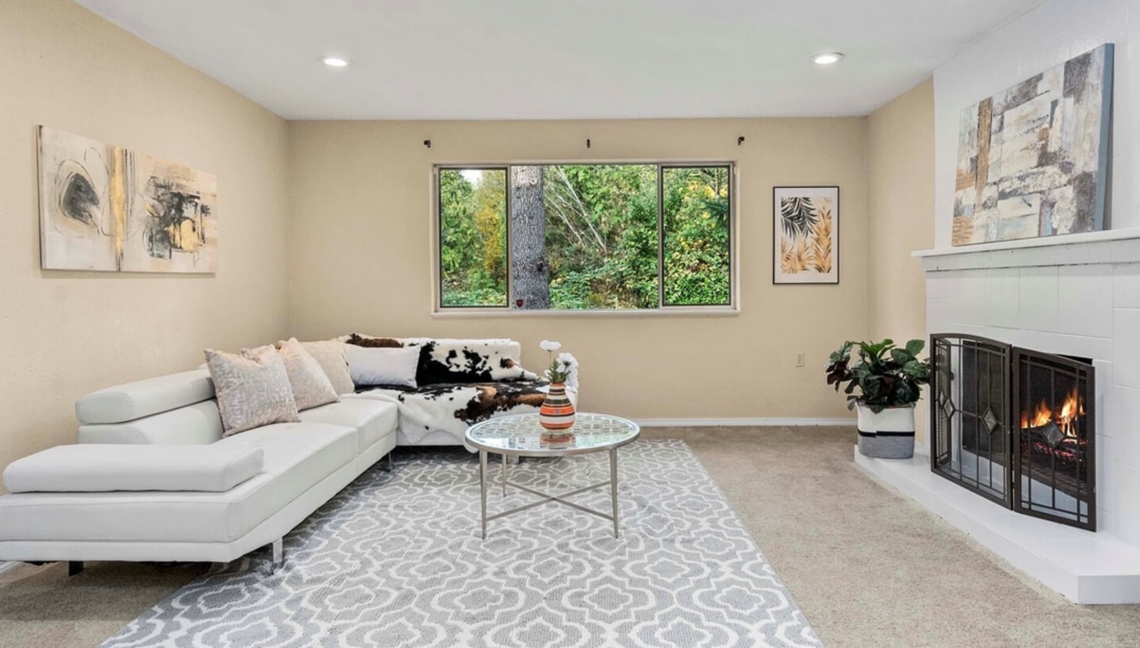 Living Room — White Leather Sectional, Cowhide Throw & Glass Coffee Table