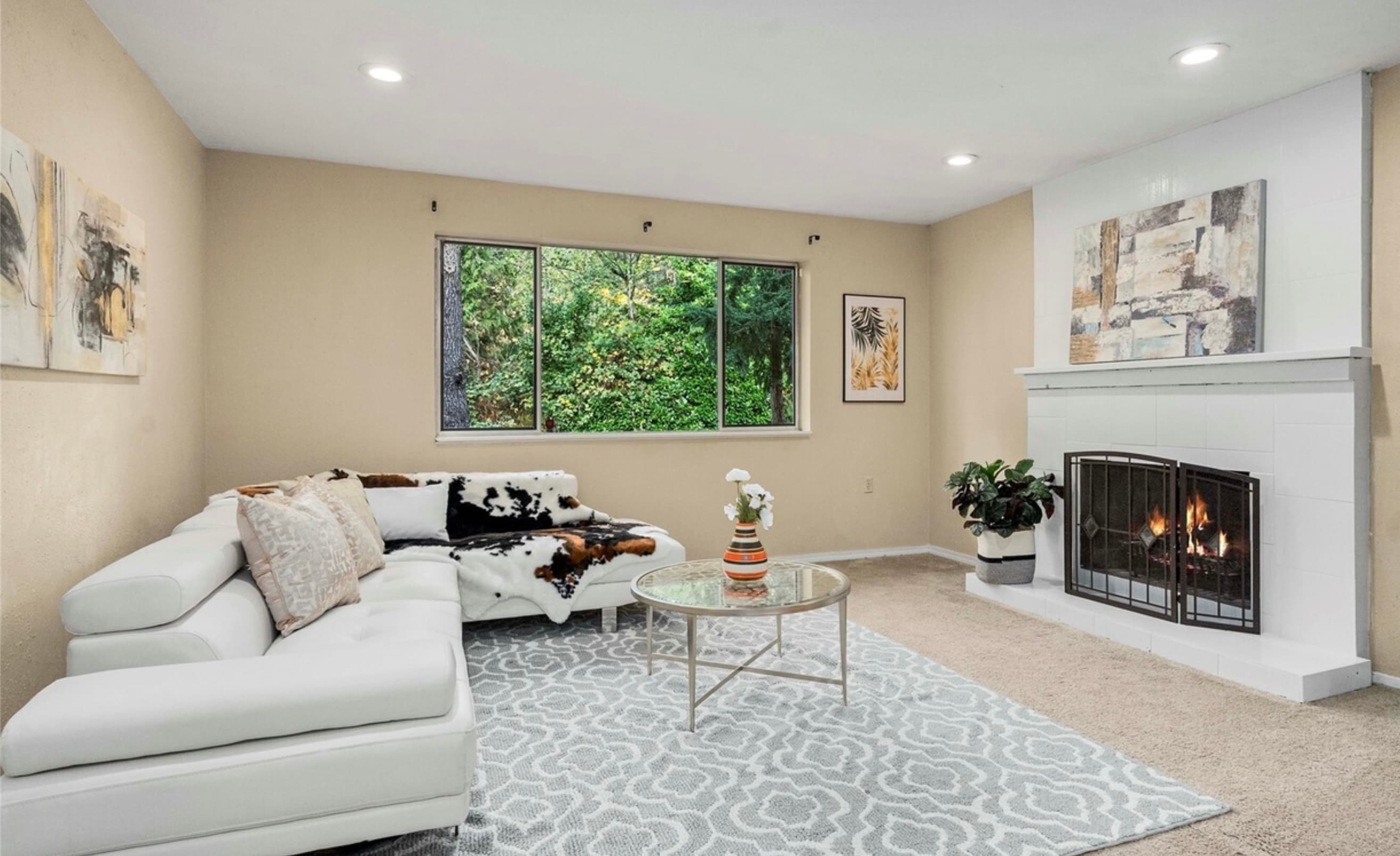 Living Room — Leather Sectional with White Brick Fireplace & Forest View