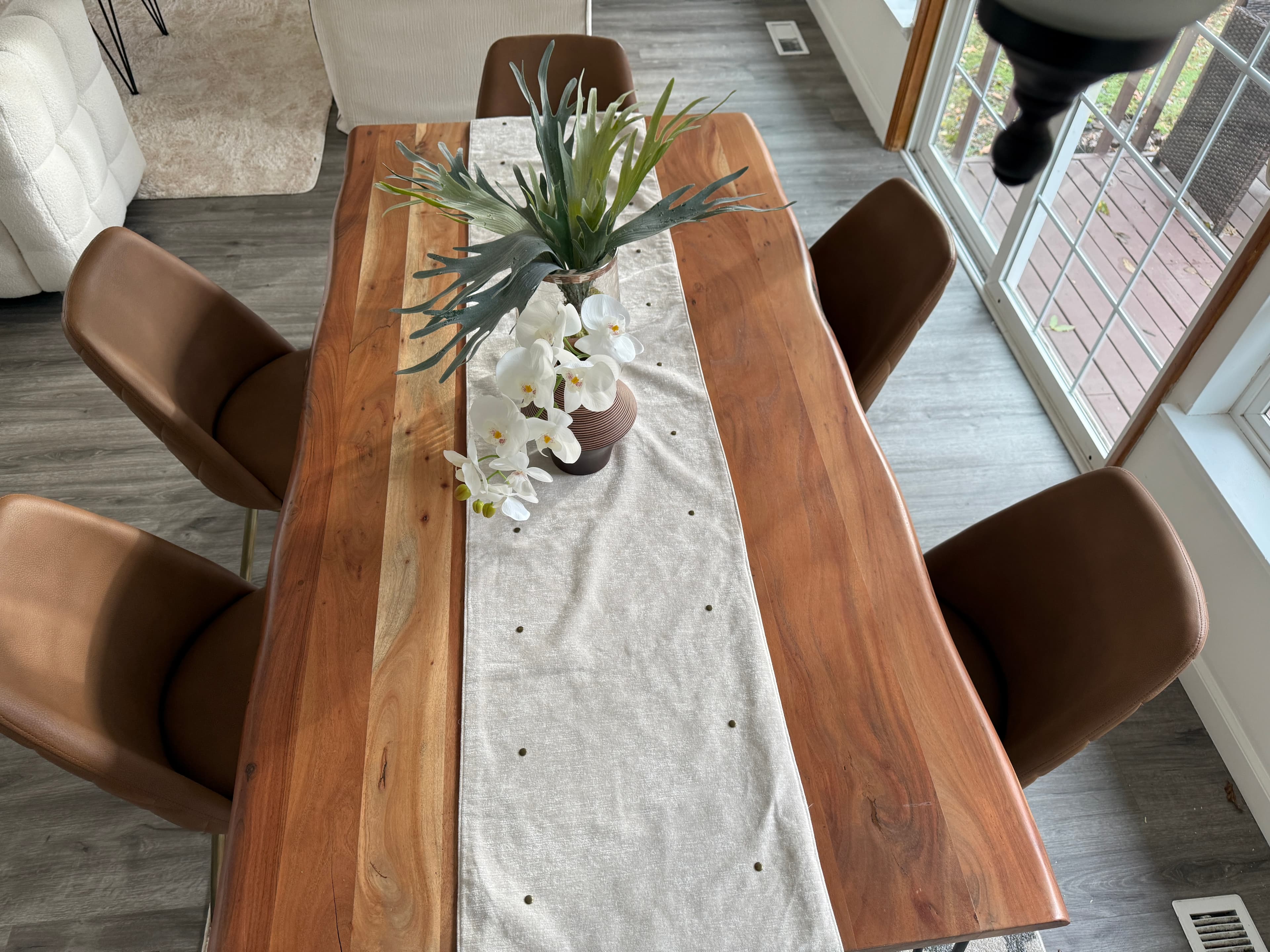 Dining Room — Live-Edge Table with Orchid Centerpiece & Outdoor View