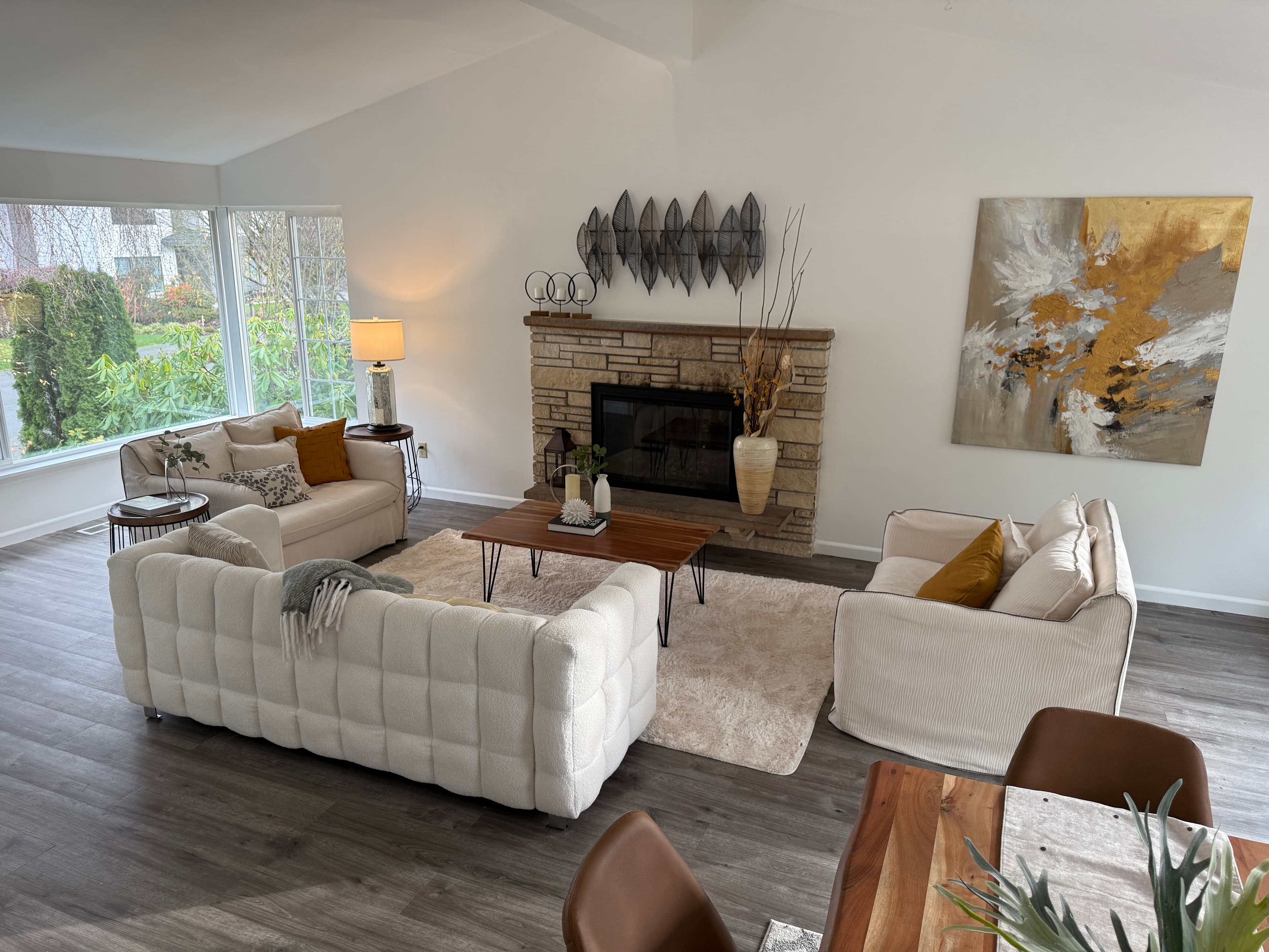 Living Room — Cream Sectional Sofas, Stone Fireplace & Gold Art