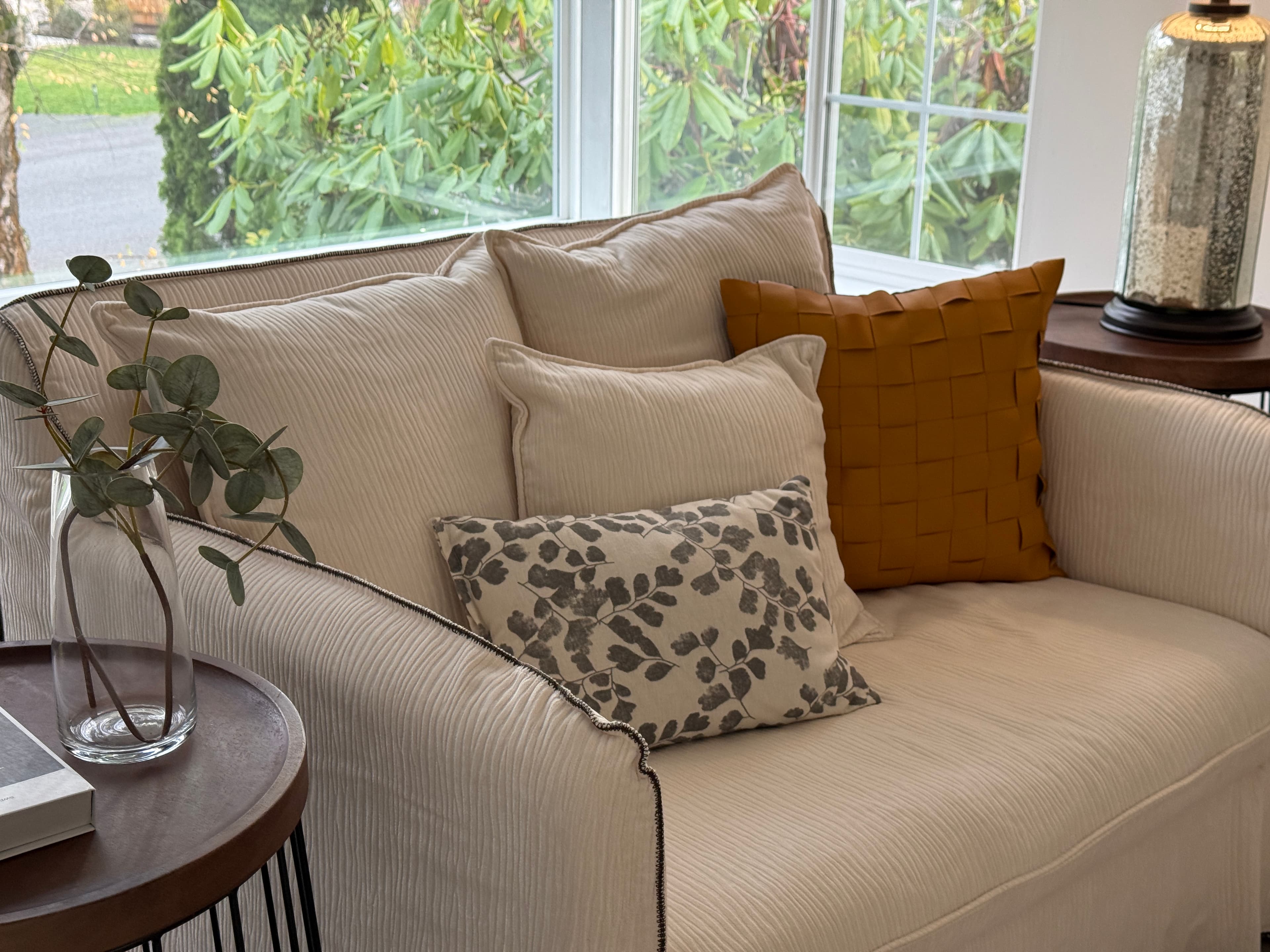 Living Room — Sofa Pillow Detail: Mustard Woven & Botanical Print