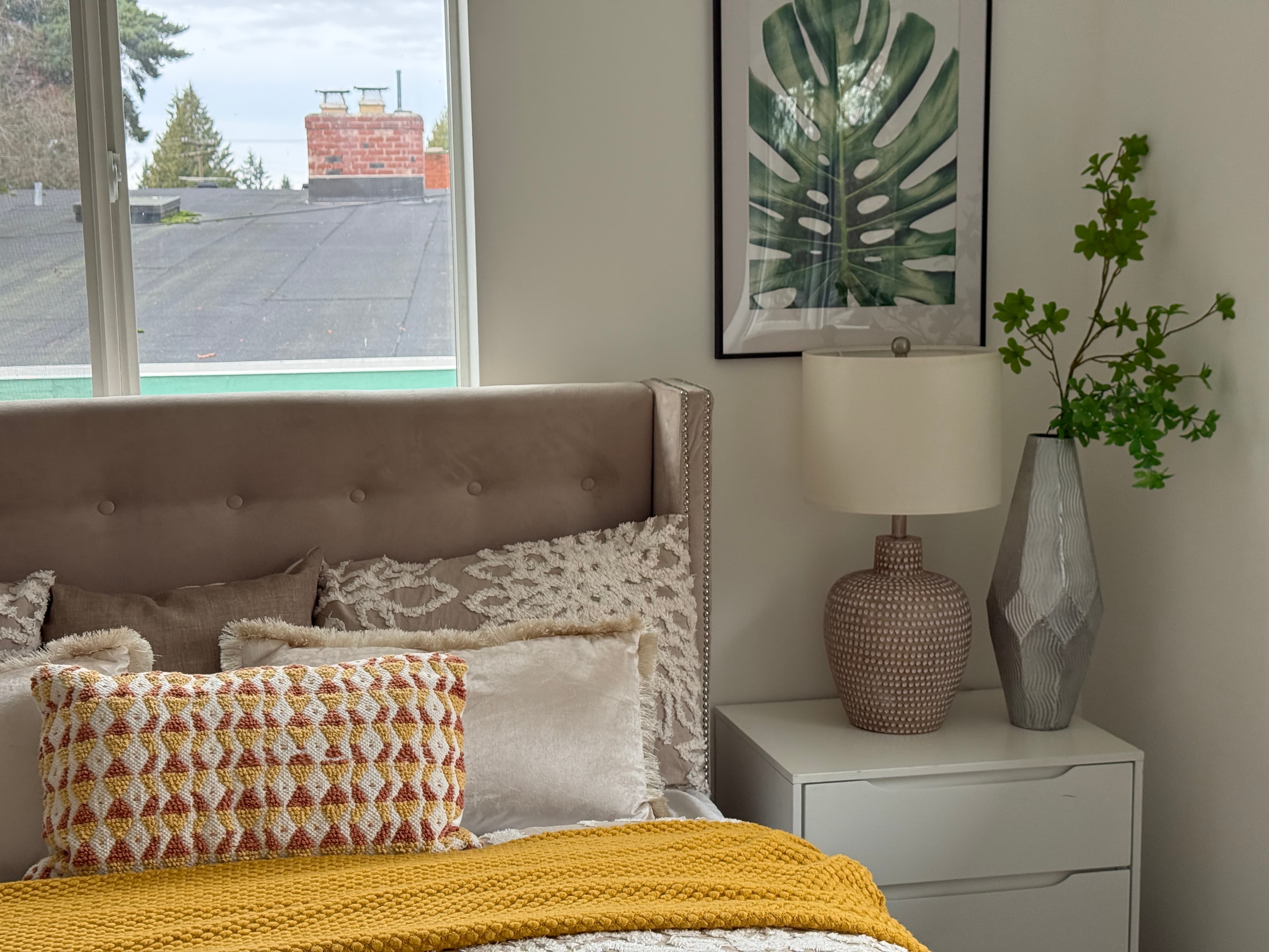Primary Bedroom — Nightstand Detail with Monstera Art & Geometric Lamp